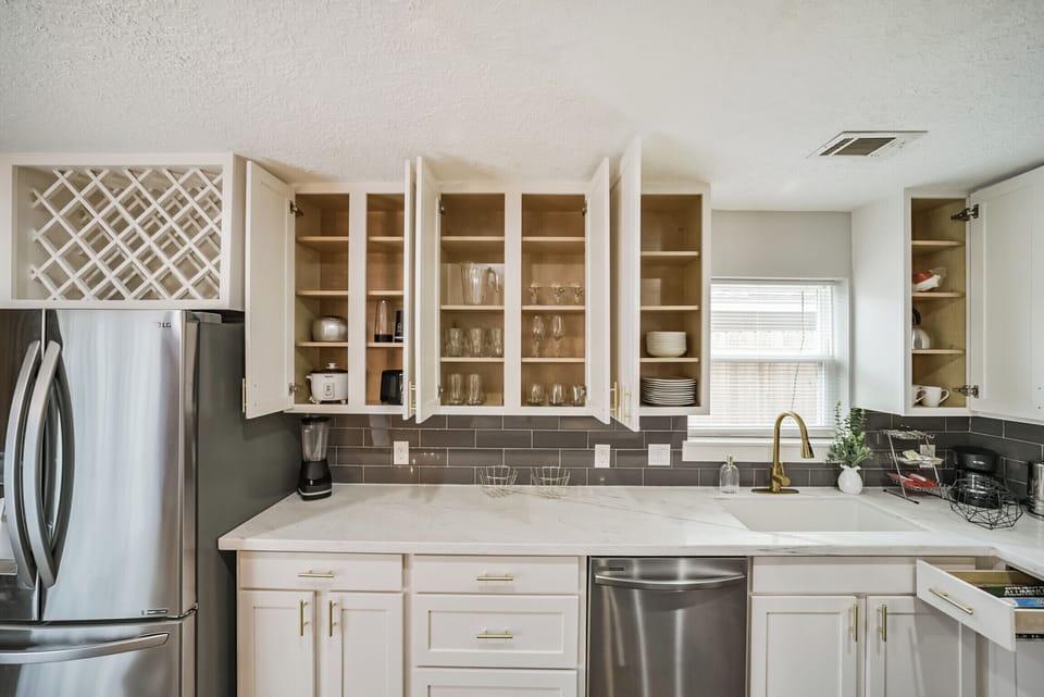 Fully equipped kitchen with modern appliances, cookware, and utensils, ready for any culinary needs.