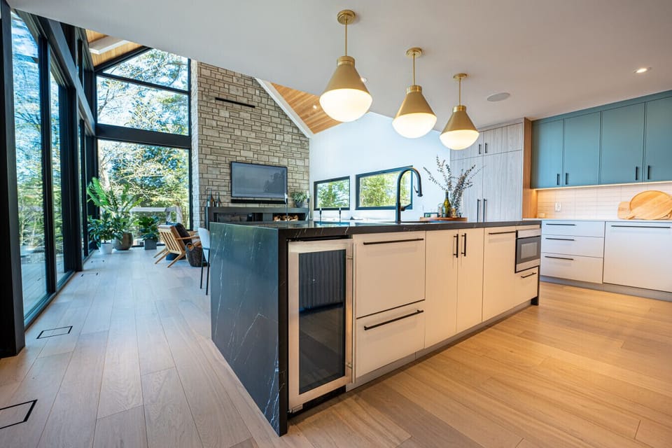 . The left wing is all about entertainment, featuring a gourmet kitchen with top-of-the-line amenities including an espresso station, a large island, and a dining table that seats 10.
