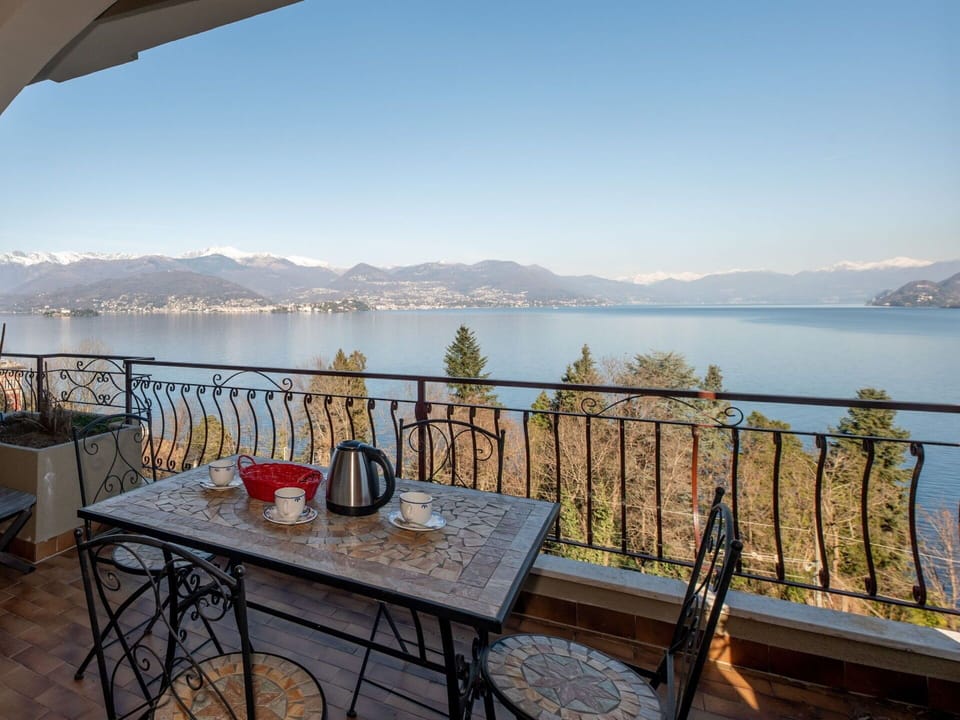 Body Of Water, Furniture, Coastal And Oceanic Landforms, Bank, Coast, Sea, Lake, Chair, Mountain Range, Balcony