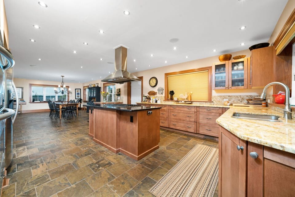 The homes spacious kitchen is fully equipped with a walk-in pantry, gas stove, double oven and everything you need to craft memorable meals