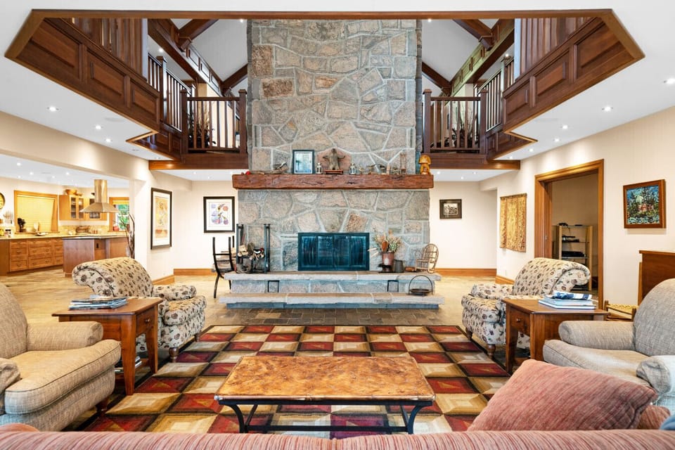 The centerpiece of this home is an impressive 18-foot stone wood-burning fireplace, commanding attention with its grandeur and rustic charm