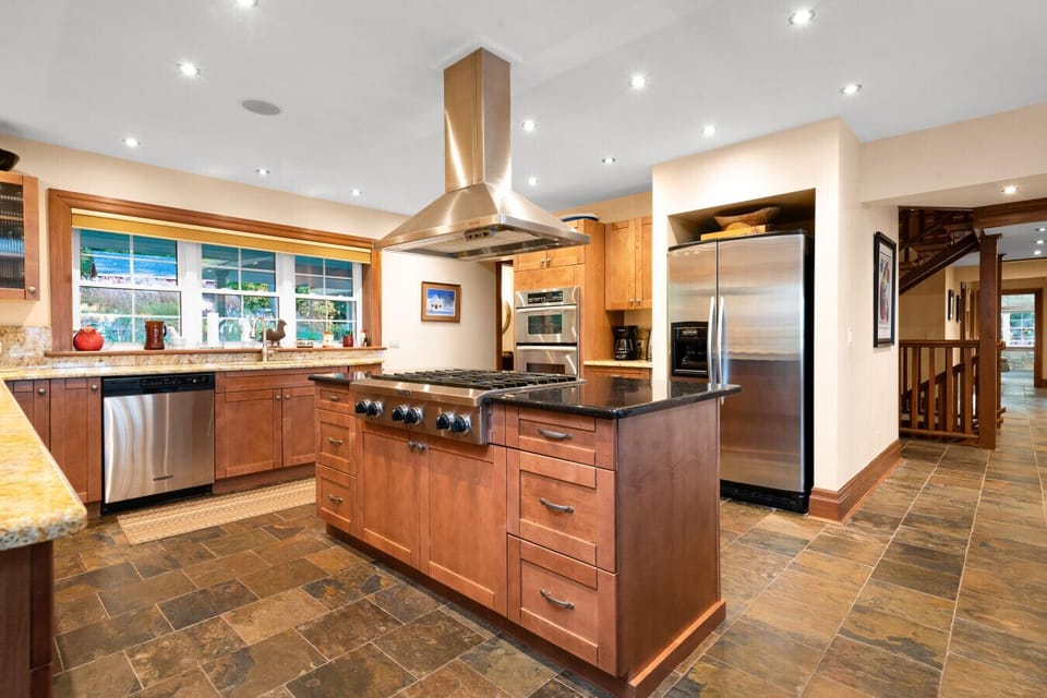 The homes spacious kitchen is fully equipped with a walk-in pantry, gas stove, double oven and everything you need to craft memorable meals