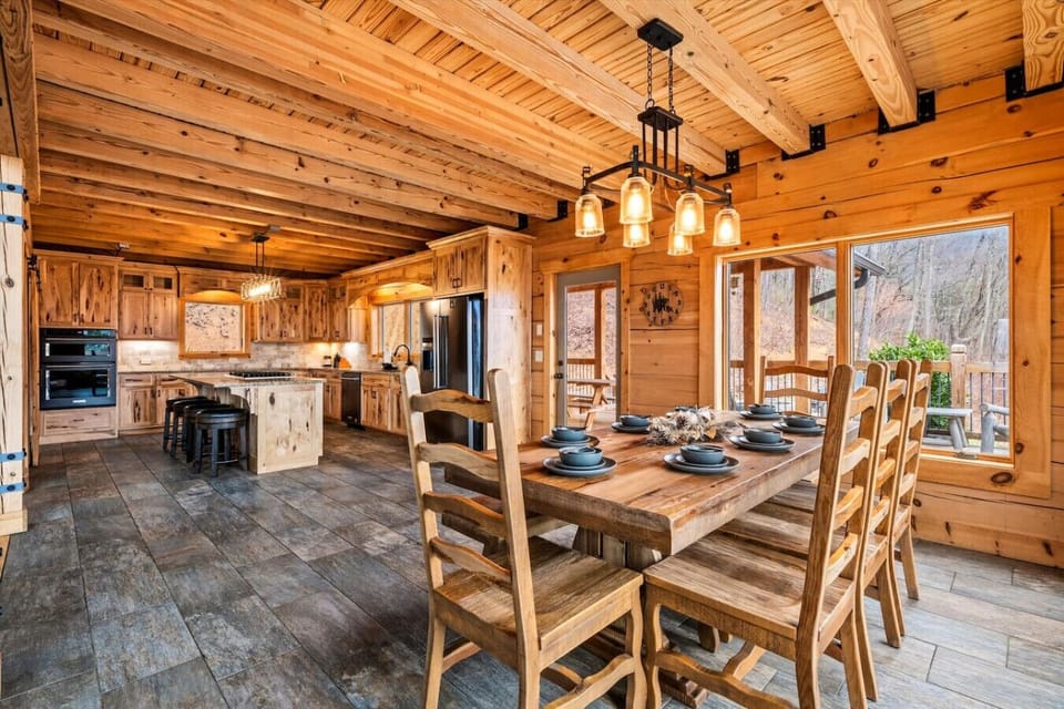 A seamless blend of rustic charm and modern convenience, this fully equipped kitchen opens to a spacious dining area with views that make every meal unforgettable.