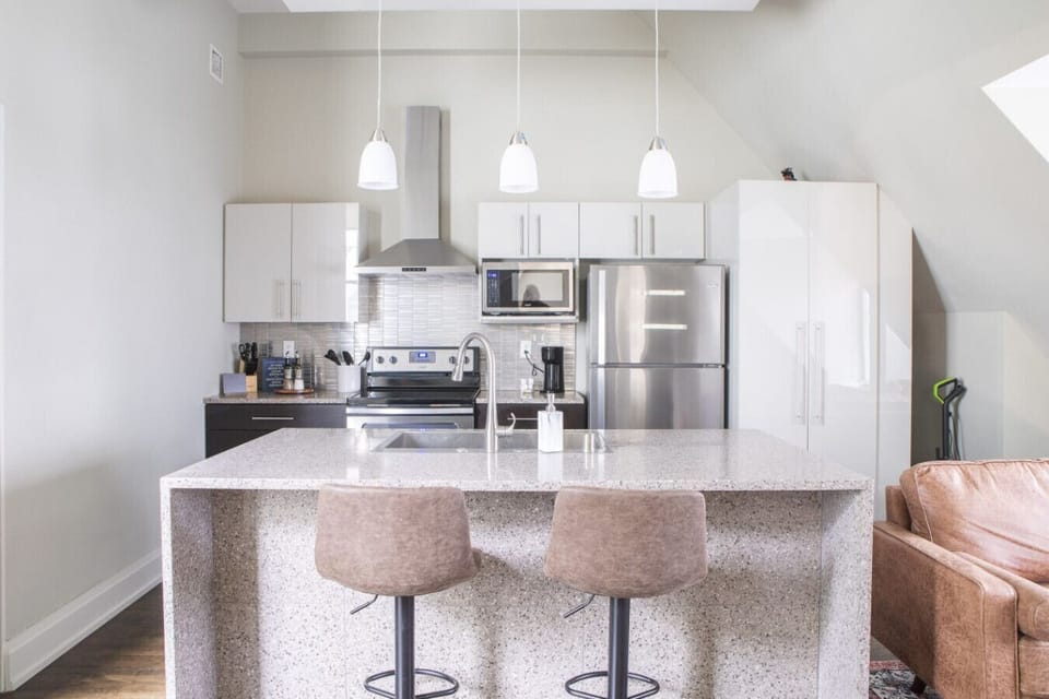 Kitchen with bar stool seating and in-unit laundry