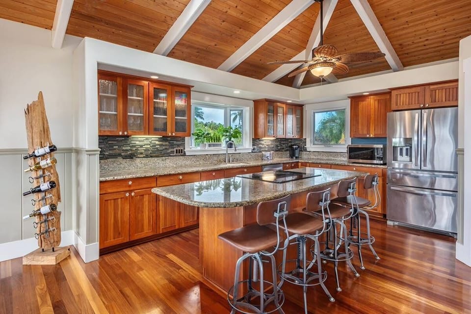 - Cook with ease in the kitchen with granite counters   - Large island with bar stools for quick casual bites   - Stainless appliances and wood cabinets all around