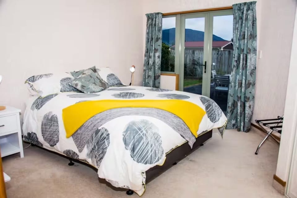 Bedroom 4 - Queen bed, doors opening onto garden area