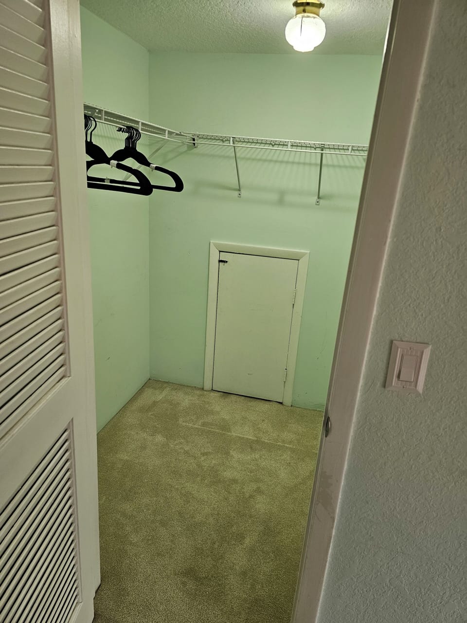 Walk-in closet with hangers supplied.