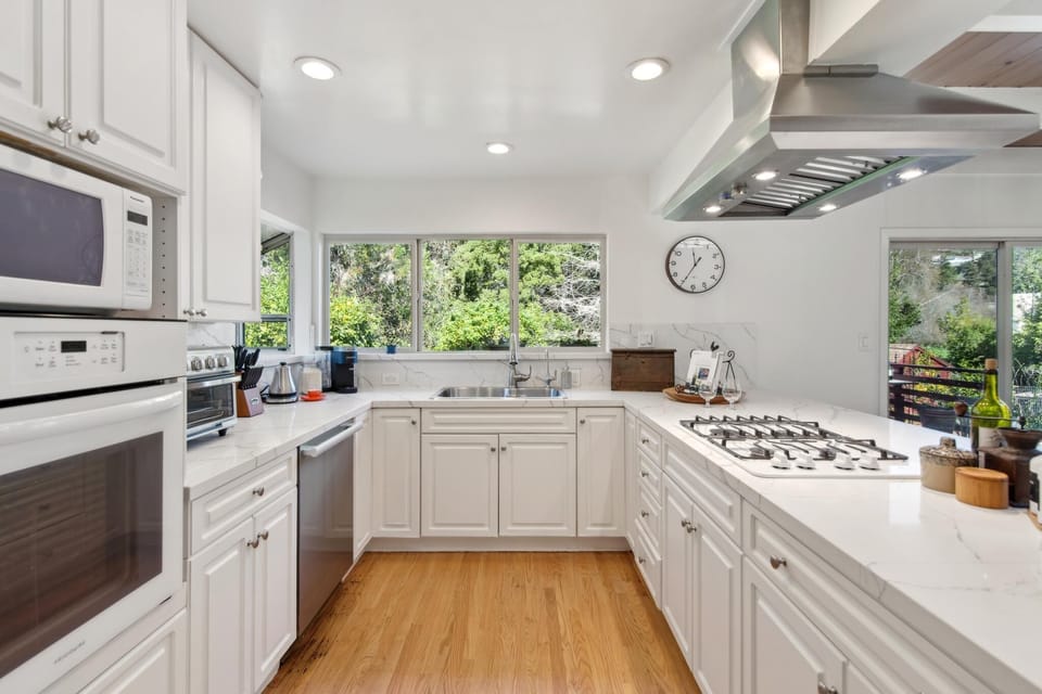 Features high-end appliances and ample cabinetry for all your cooking needs. 