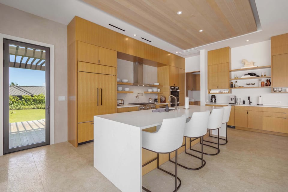 Kitchen with accent lighting, waterfall countertops...