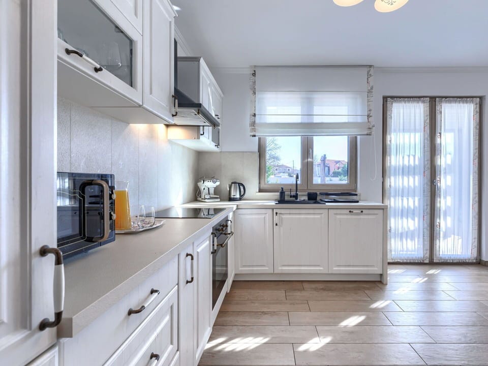 Kitchen, Countertop, Interior Design, Furniture, Cabinetry, Kitchen Appliance, Flooring, Home, Major Appliance, Lighting