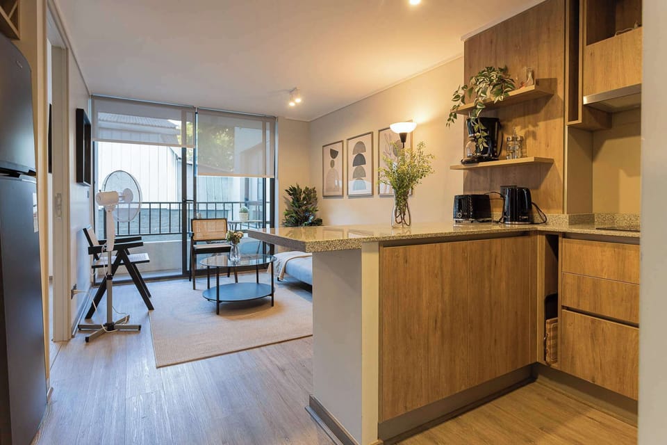 Chic studio with a cozy living area and balcony, perfect for a relaxing stay in the heart of Chile.