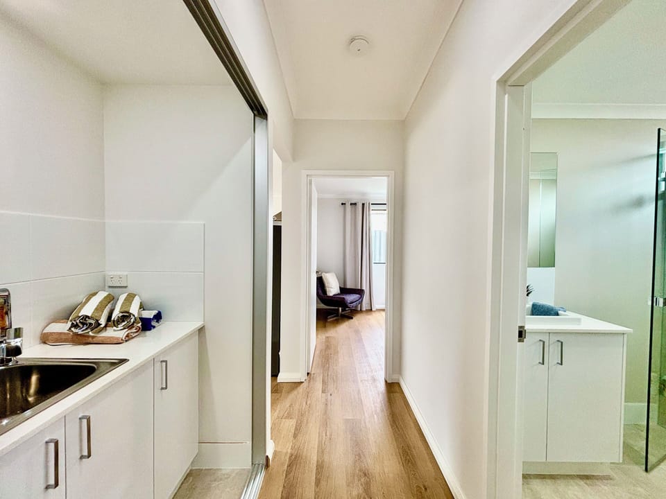 Laundry, full bathroom all connected by the hallway between the bedrooms and living area in the Villa.