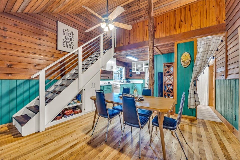 Full kitchen with dining space with lots of color and charm! Stairs leading to the lofted bedroom.