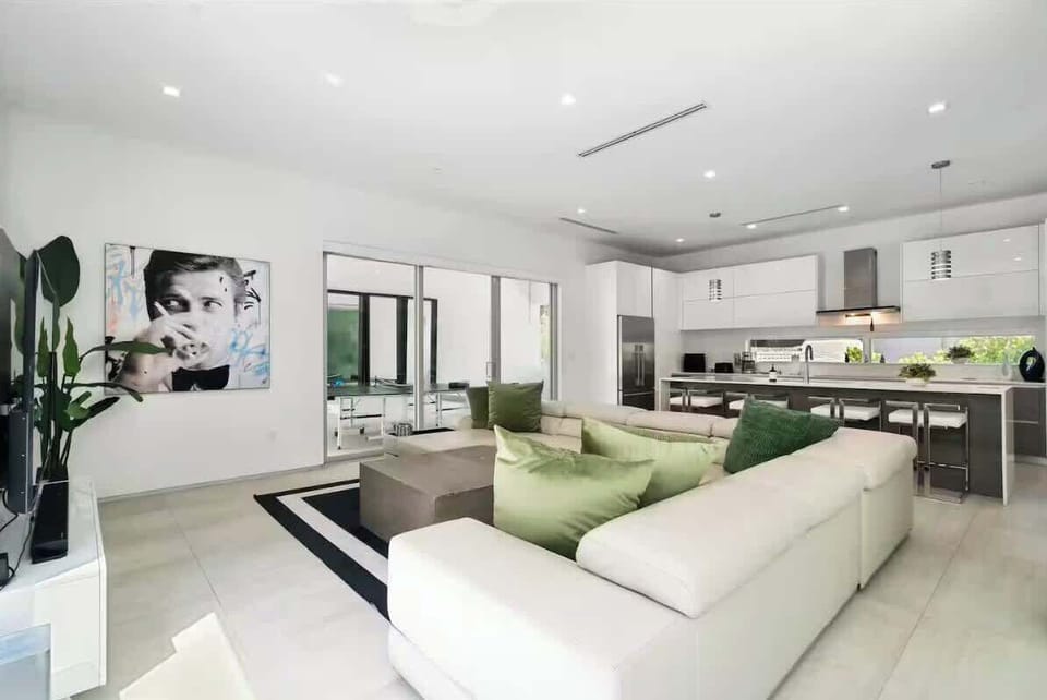 Gather, cook, and create memories in our modern open-concept space! This stylish dining area and bar are perfect for group meals, morning coffee, or evening cocktails. 