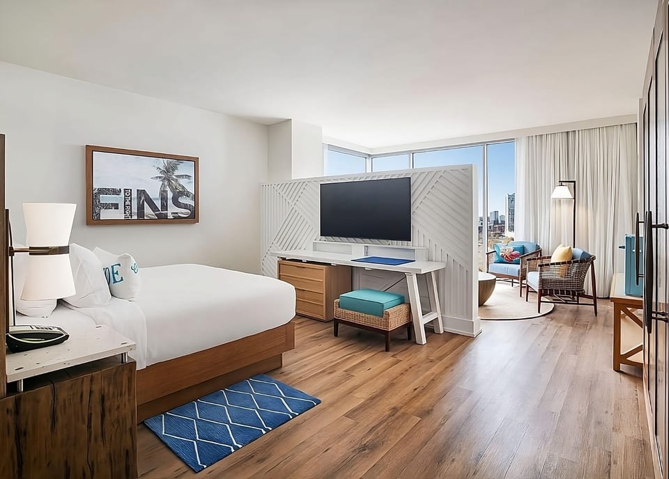 Unwind in a sunlit king bed suite with city views.