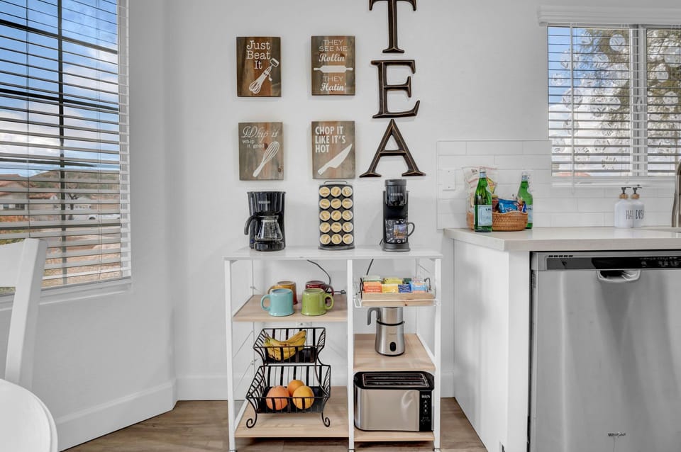 Coffee /Tea cart. Mugs and Frother. A toaster and fruit basket.