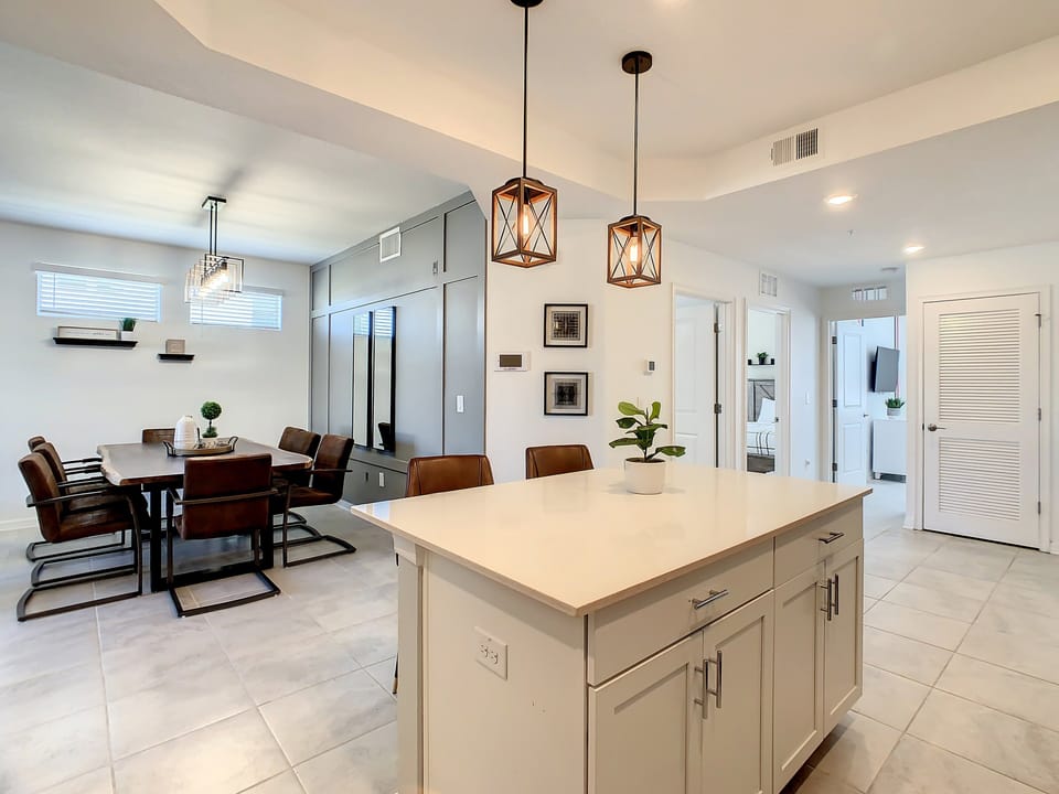 Kitchen | Island makes serving meals a breeze, conveniently located next to the dining table.