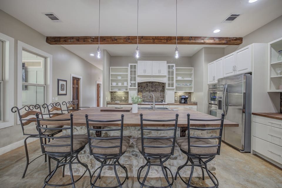 Large dining table with seating for everyone, set in a beautifully designed space with rustic accents.