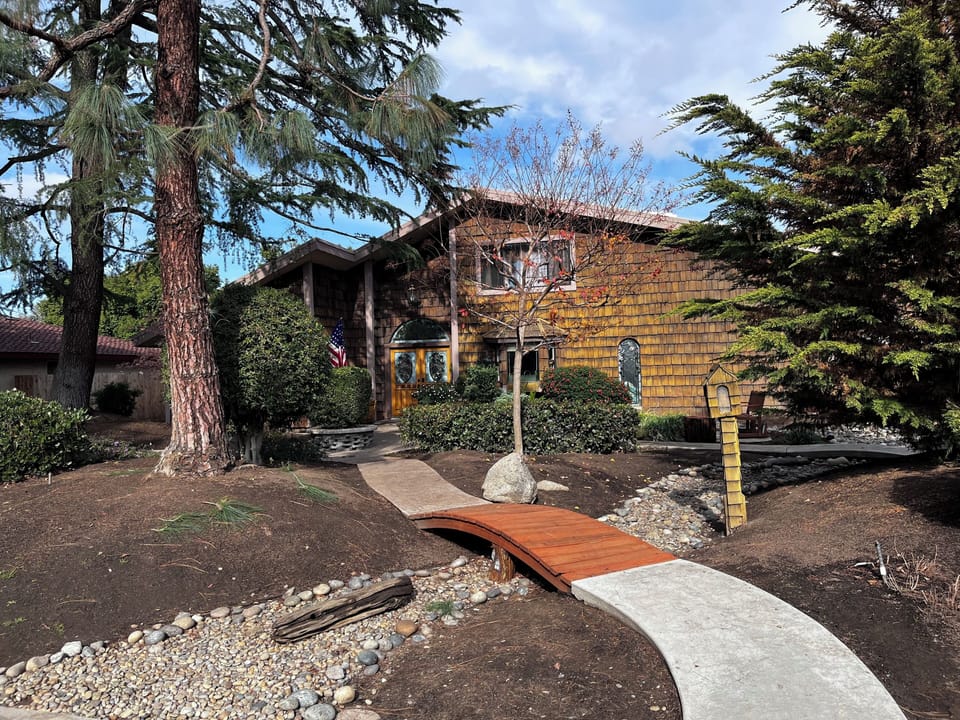 pine tree surrounded home with separate upstairs apartment