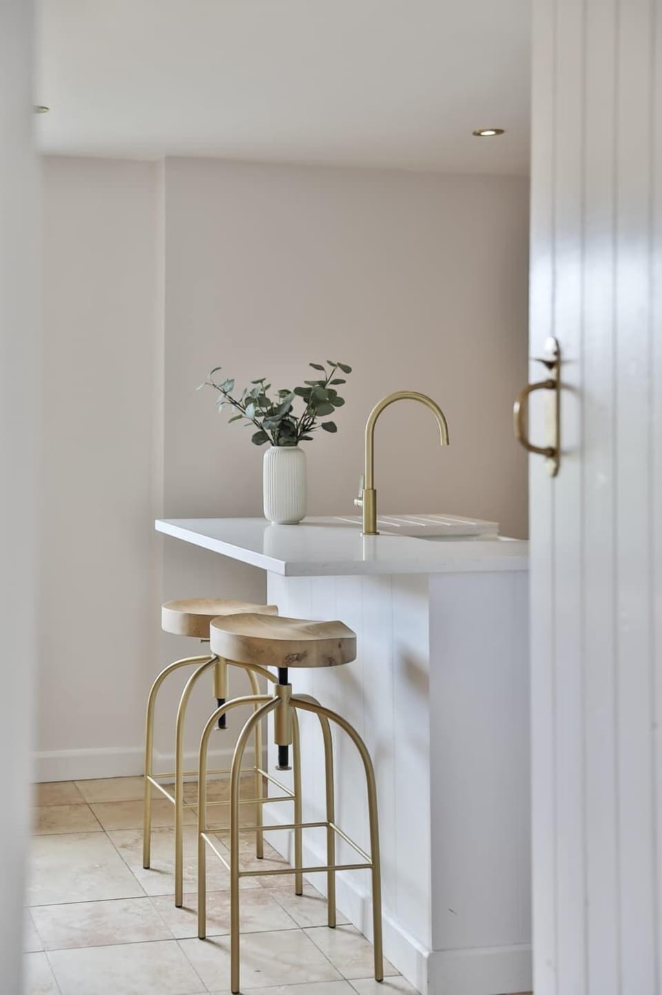 A bright, airy kitchen where mornings begin right — enjoy coffee at the breakfast bar bathed in natural light. Everything you need for self-catering stays is on hand, from modern appliances to all the essentials for relaxed holiday dining.