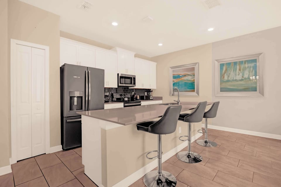 Sleek and modern kitchen with a spacious island, perfect for entertaining and family gatherings.