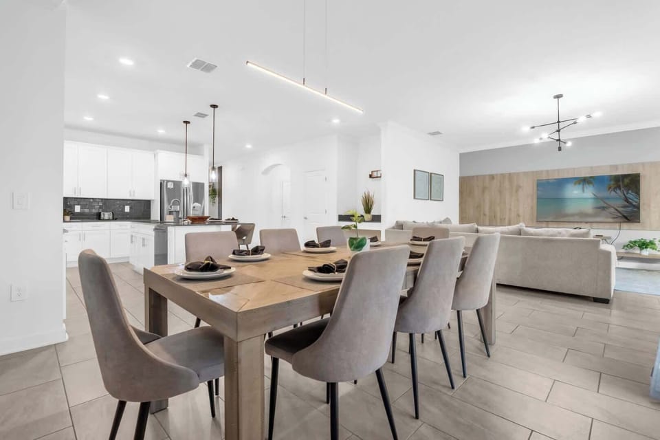 Spacious open-plan dining and living area with modern amenities, perfect for entertaining large groups in style.