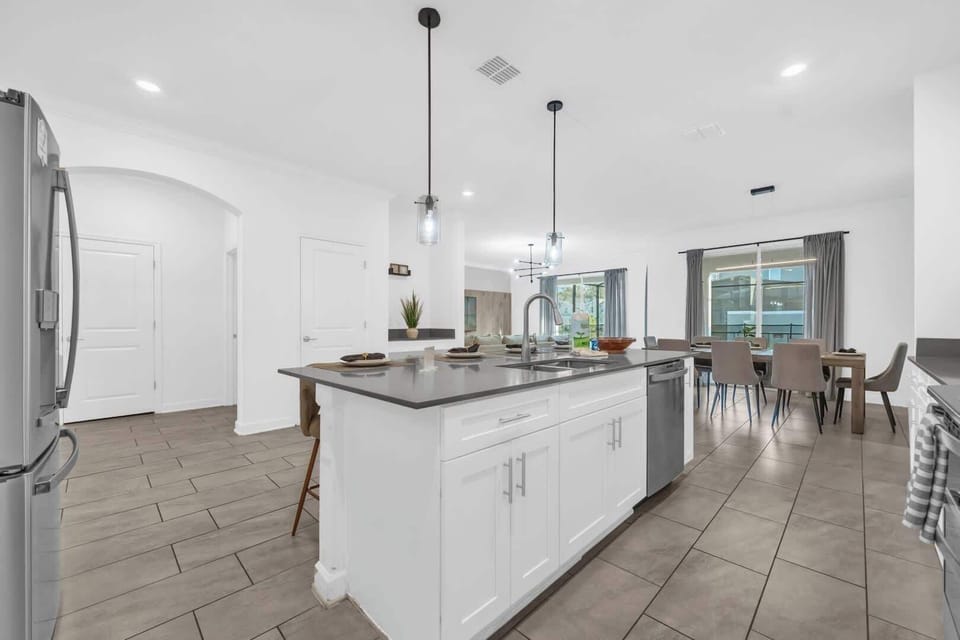 Spacious modern kitchen with sleek finishes and a large dining area, perfect for entertaining family and friends.