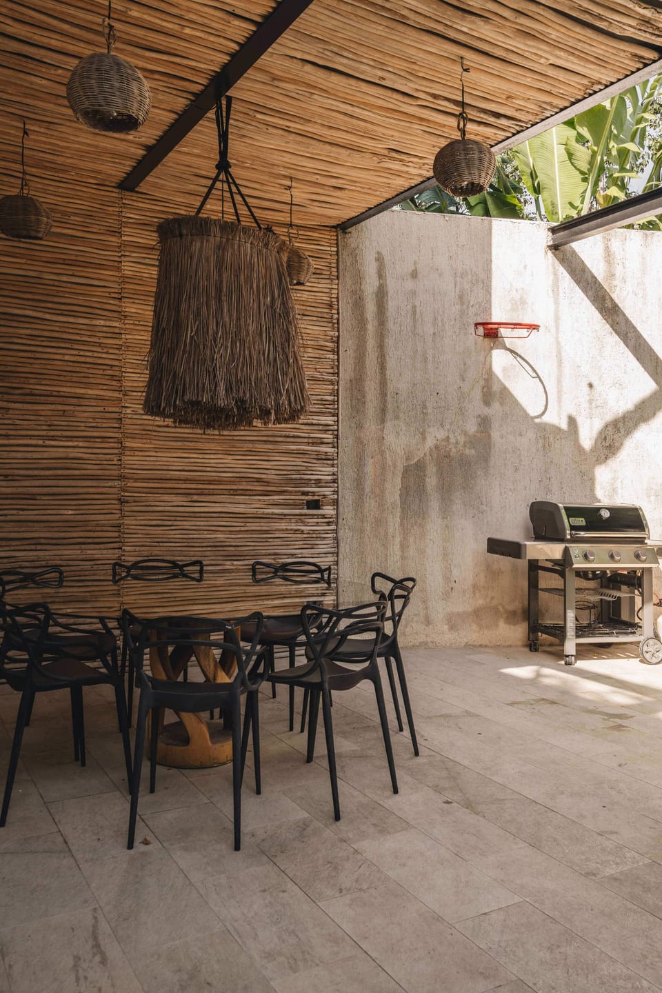 Beautiful outdoor dining area with a grill, located in the ground floor patio.