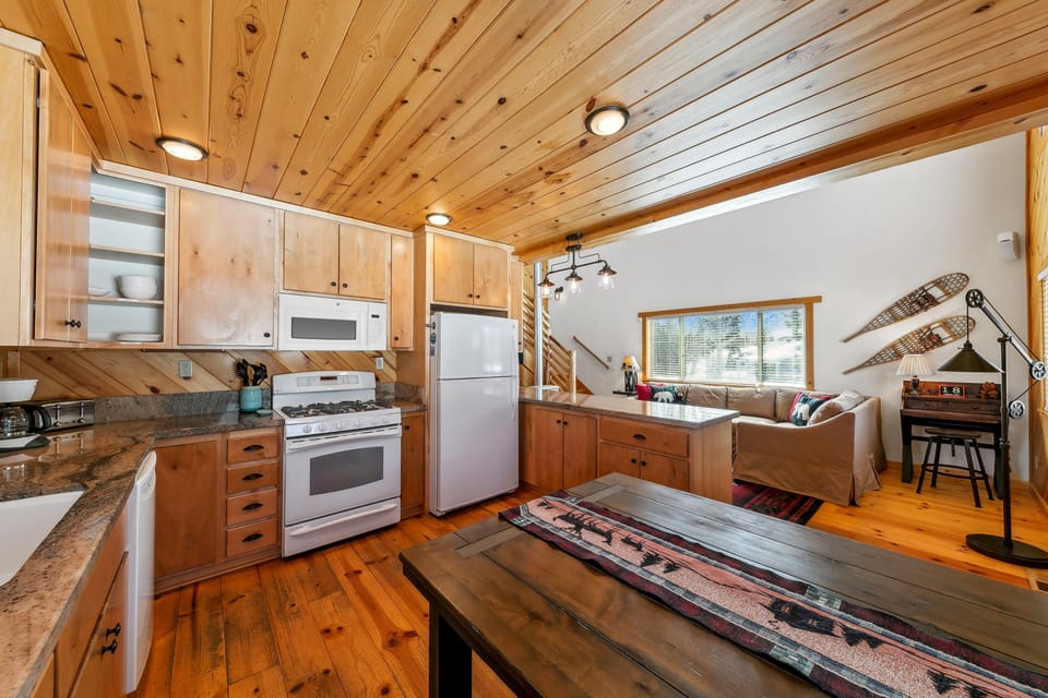 Full sized appliances and seating for four at the kitchen table in the kitchen