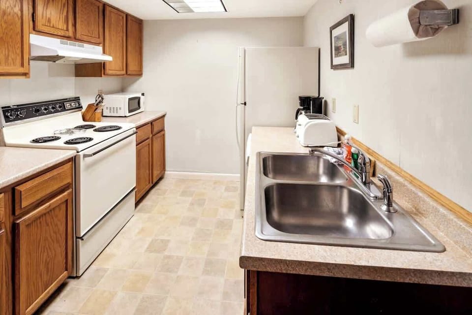 Unleash your culinary creativity in this stylish galley kitchen, equipped with appliances.