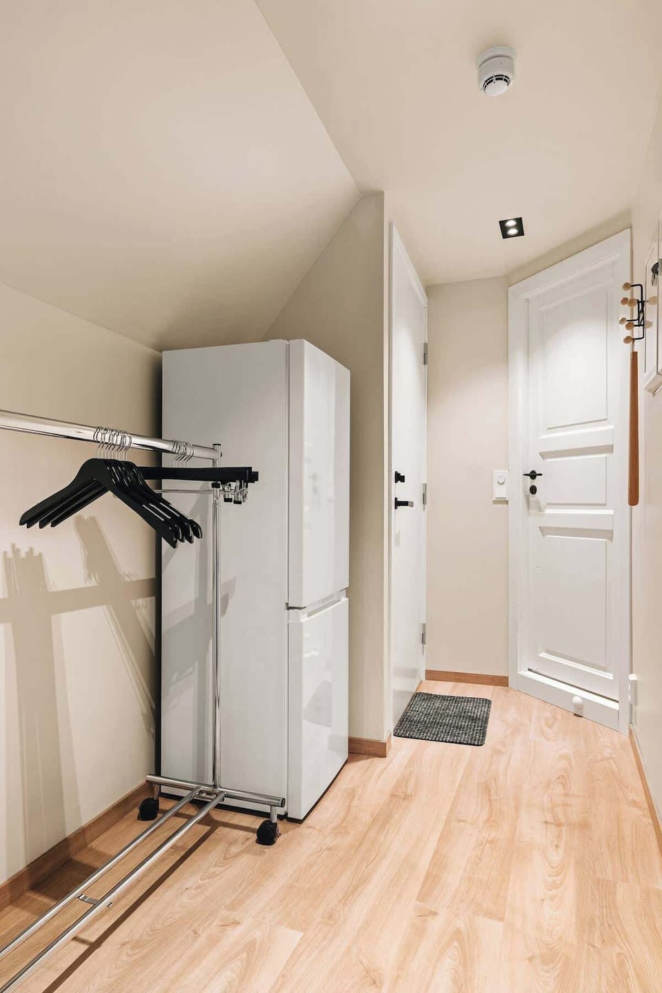 Compact and modern entryway with practical furnishings.