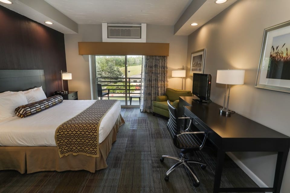 Spacious room featuring a cozy bed and private balcony access, perfect for enjoying fresh air.