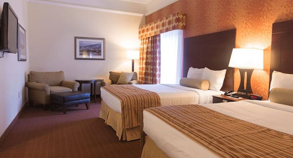 Cozy room with comfortable bedding and a sitting area, perfect for unwinding after a busy day.