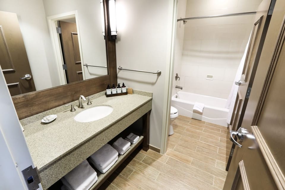 Stylish bathroom with a large vanity and walk-in shower, offering convenience and comfort.
