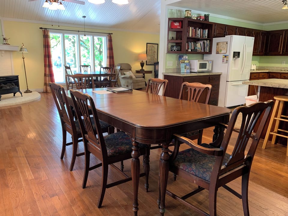 Dining room table can seat up to 8 people. 2nd table, by the window, seats 4.