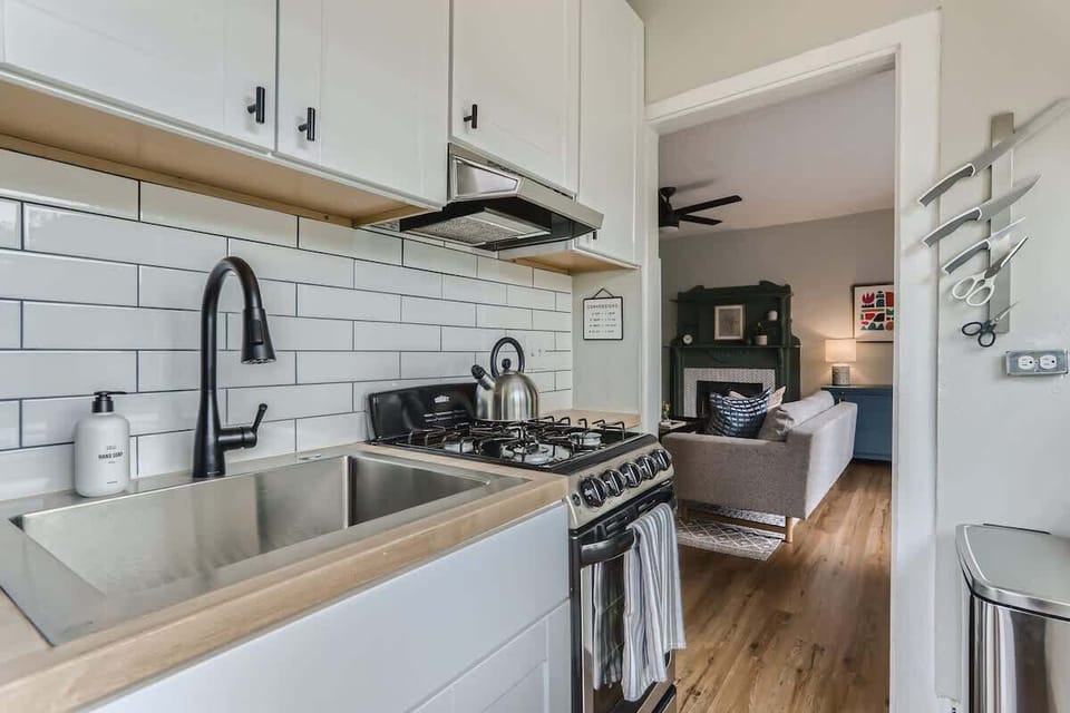 The kitchen is stocked with cooking essentials and also gets a lot of light from the windows