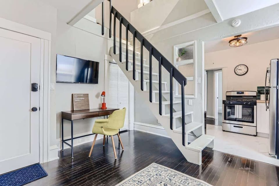 Beautiful staircase to loft with an office area situated underneath it and a Smart TV
