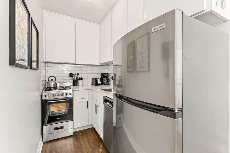 This kitchen makes the most of the space with lots of cabinet spaces and a large fridge 