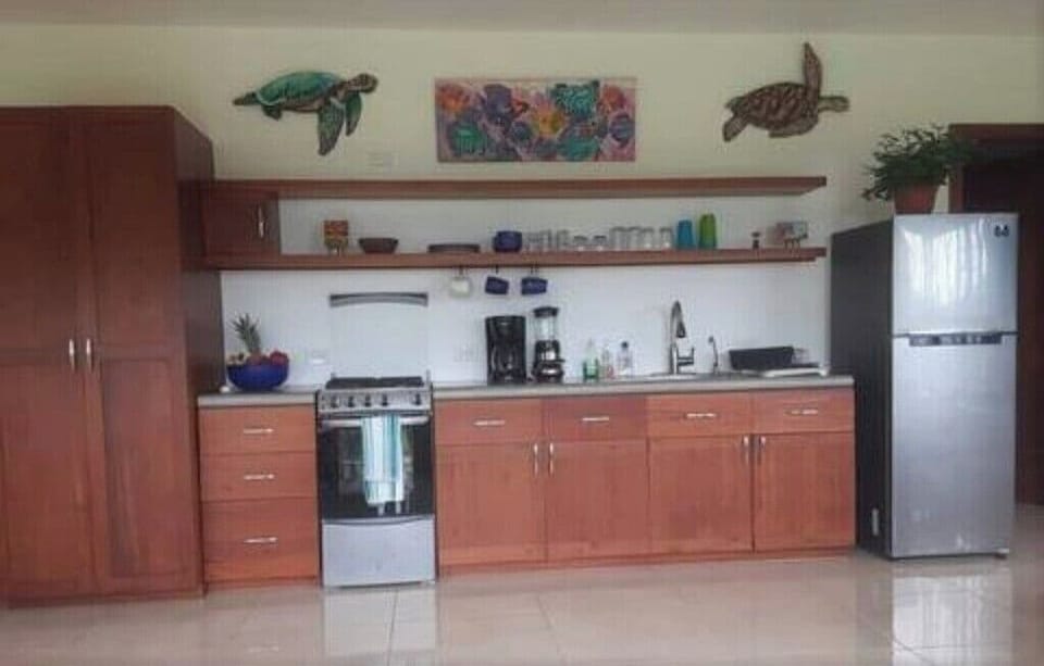 fully stocked kitchen with coffee maker, blender, food processor