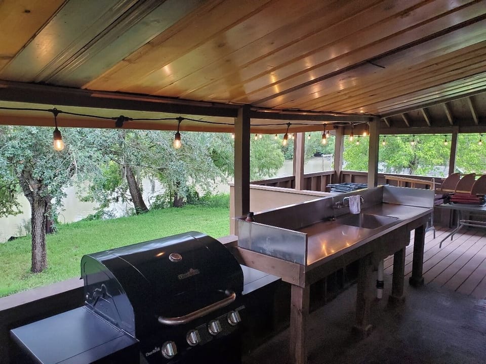 Patio with outdoor dining and fish cleaning station