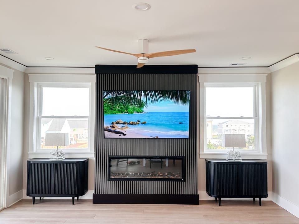 Fireplace in living room. 75” smart tv with ocean views