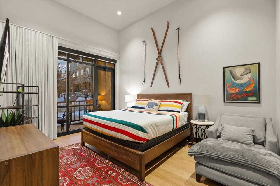 Master Bedroom with private patio entrance and remote control operated, room-darkening shades.