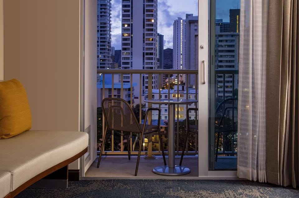 Step onto the balcony and savor twinkling city views.
