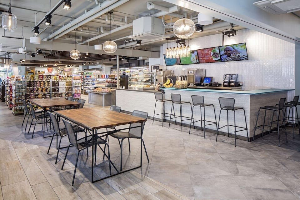 Grab fresh snacks and coffee anytime in the airy marketplace.