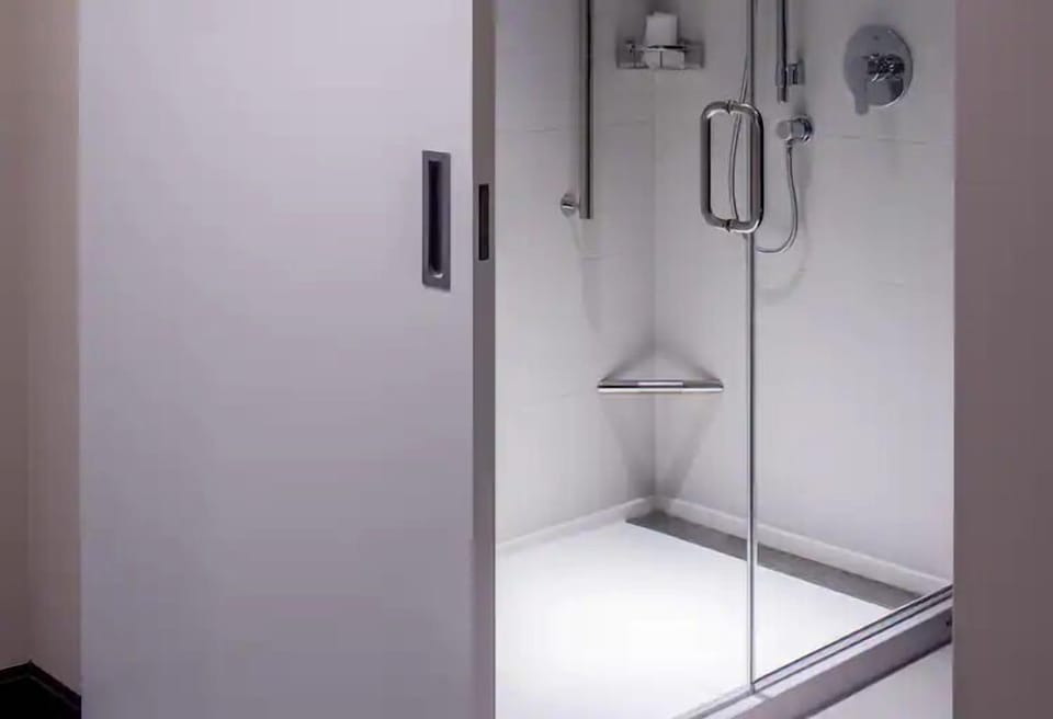 Rinse off in a sleek glass shower with modern fixtures.
