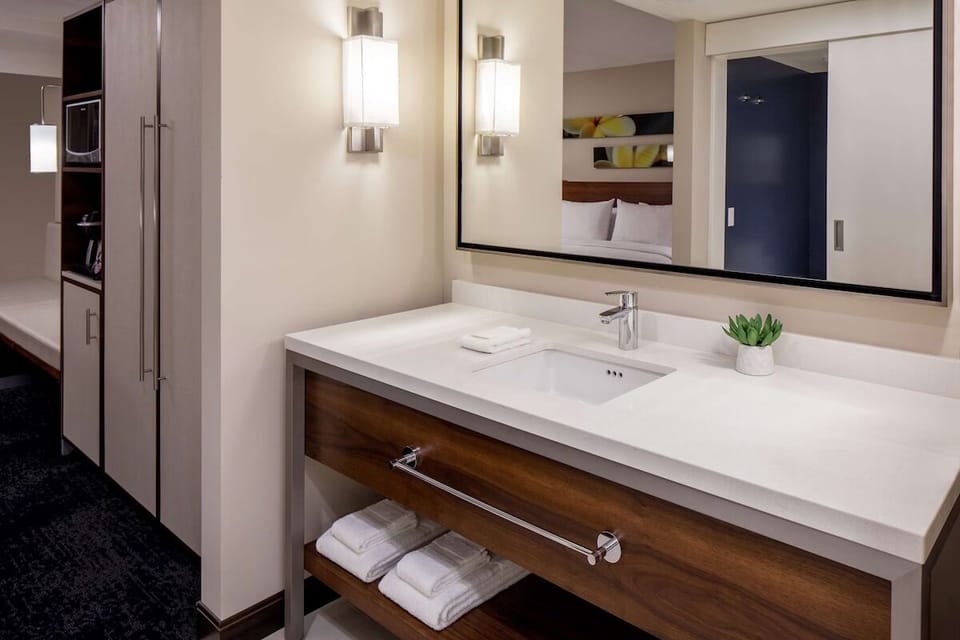 Refresh at a sleek vanity with bright, spa-like lighting.