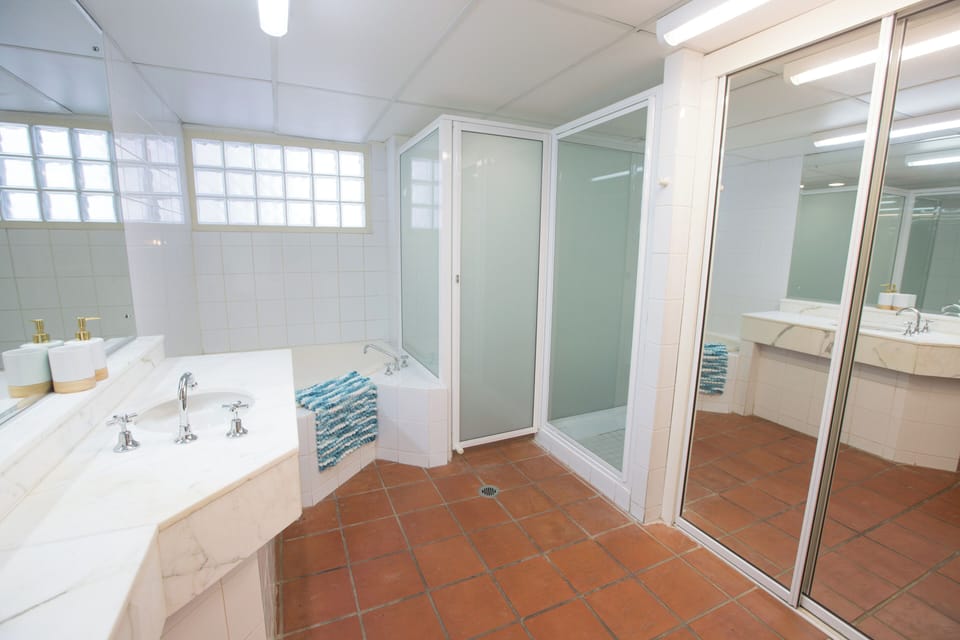 Large bathroom with spa-bath, shower and toilet.  Towels and amenities provided