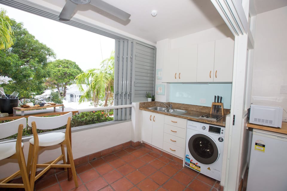 Kitchenette includes induction stovetop, washer/dryer, microwave and kitchenware