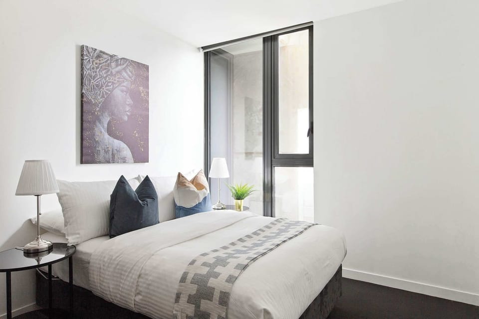 The 2nd bedroom with a double sized bed & plush pillows.