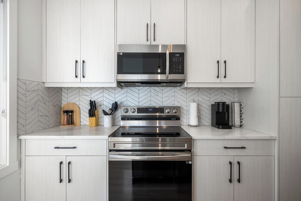 Multiple Coffee Options Available: This home features several coffee options, including a Keurig, a pour-over setup (bring your favourite ground coffee), and a Nespresso Zenius machine. Note that the Nespresso pods can only be purchased via Your Key